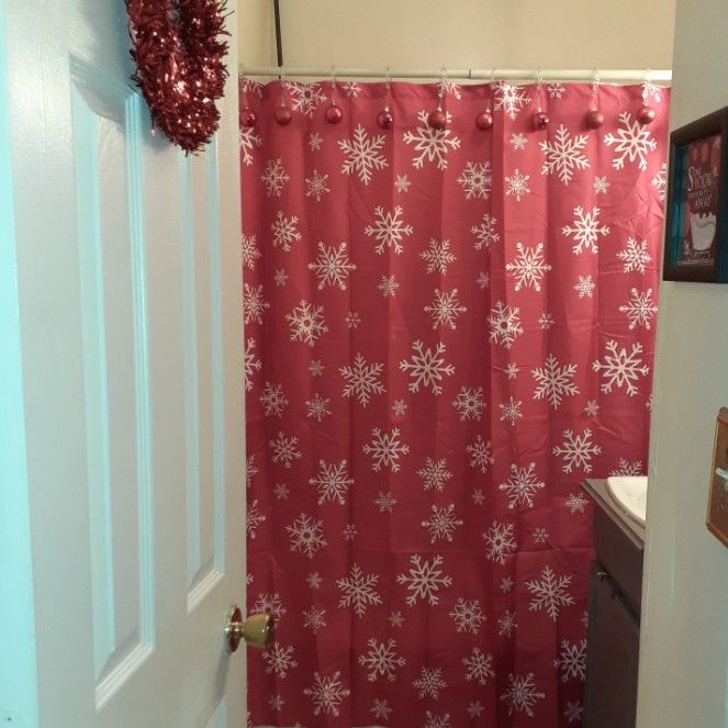 Christmas Bathroom curtain decor with ornaments.