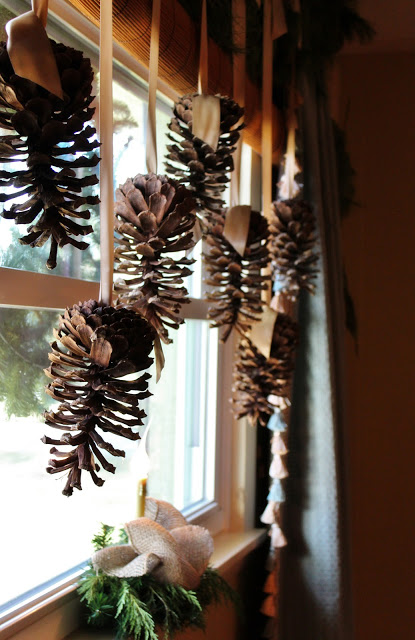 Hang Pine Cones with the Help of Fancy Ribbons for Window Decoration.