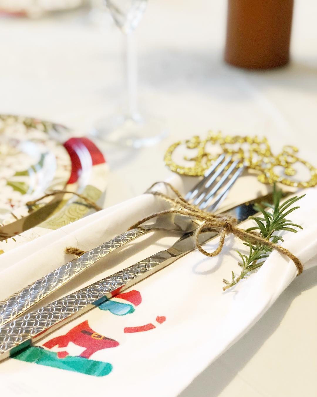 Table is set with cloth napkins & paper plates.