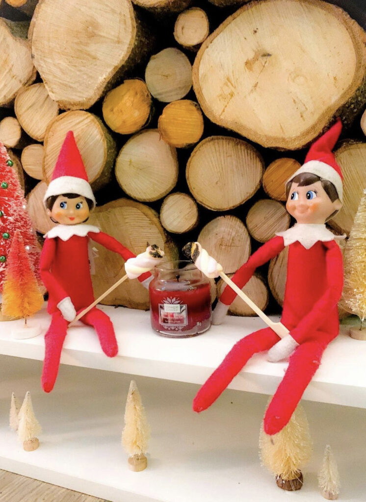 Elves toasting marshmallows over a candle
