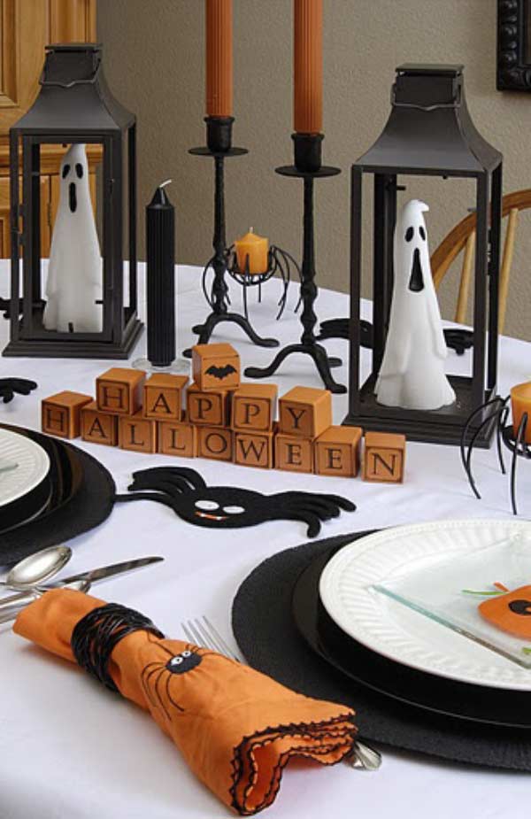 Lovely Halloween table decor from the ghosts inside the lanterns to the Happy Halloween blocks