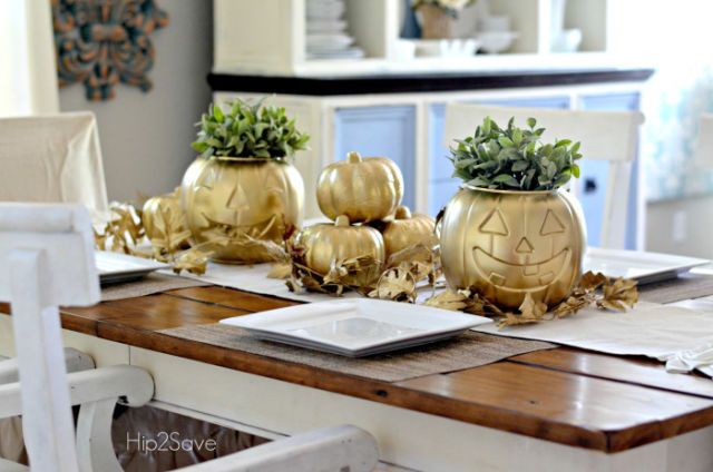 Plastic pumpkins stand out with some gold spray paint and pretty greenery