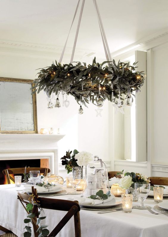 Amazing wreath chandelier decorated with silver ornaments and light.