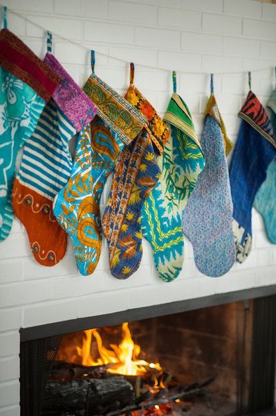 Bohemian-style Christmas stockings for fireplace decoration.