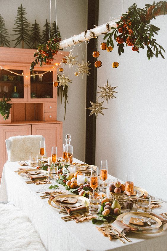 Boho-style Christmas dining space decoration with string lights.