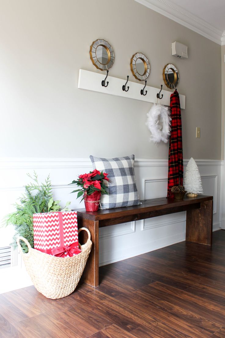 Feather wreath, brush tree, plaid fabric pillow, and gift at the entrance. 