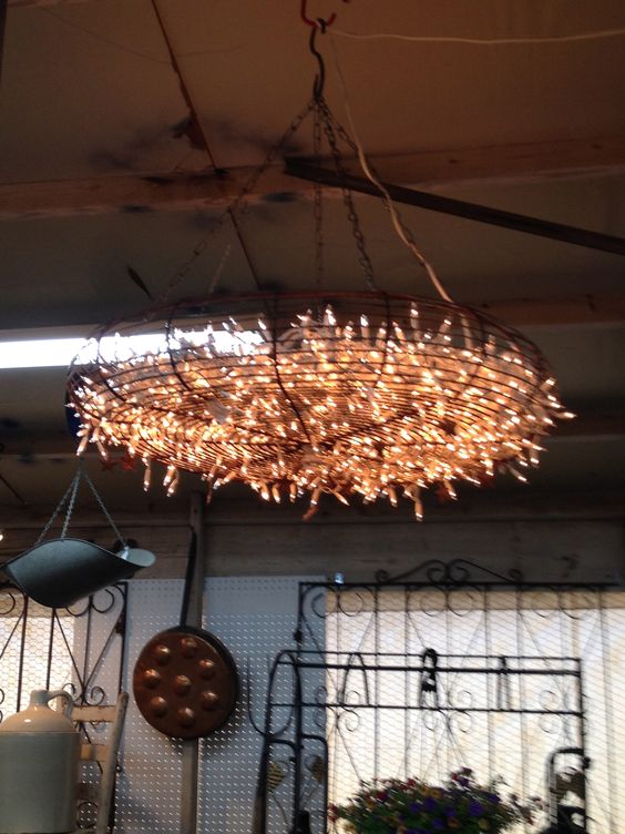 Giant fan cover with Christmas lights used as a chandelier.