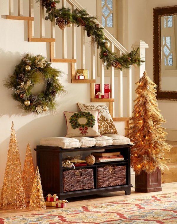 The golden entryway looks amazing with Christmas-themed pillows. 