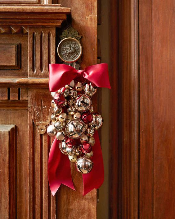 Jingle bell ornaments with red ribbon for the front door.