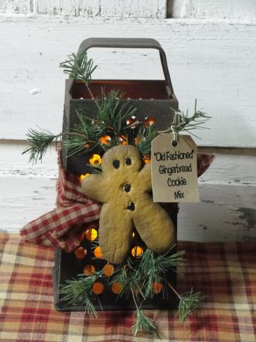 Old cheese grater with resin gingerbread and wispy pine.