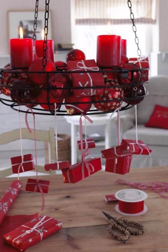 Red candles, ornaments, and gifts hanging from the chandelier.