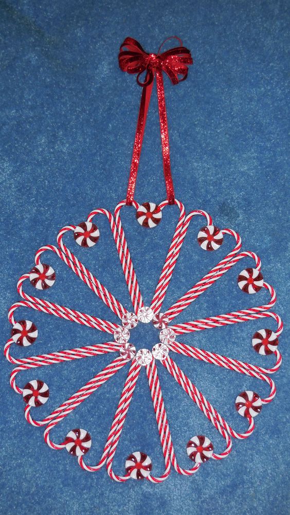 Reusable candy cane and peppermint wreath made with plastic ornaments and mints.