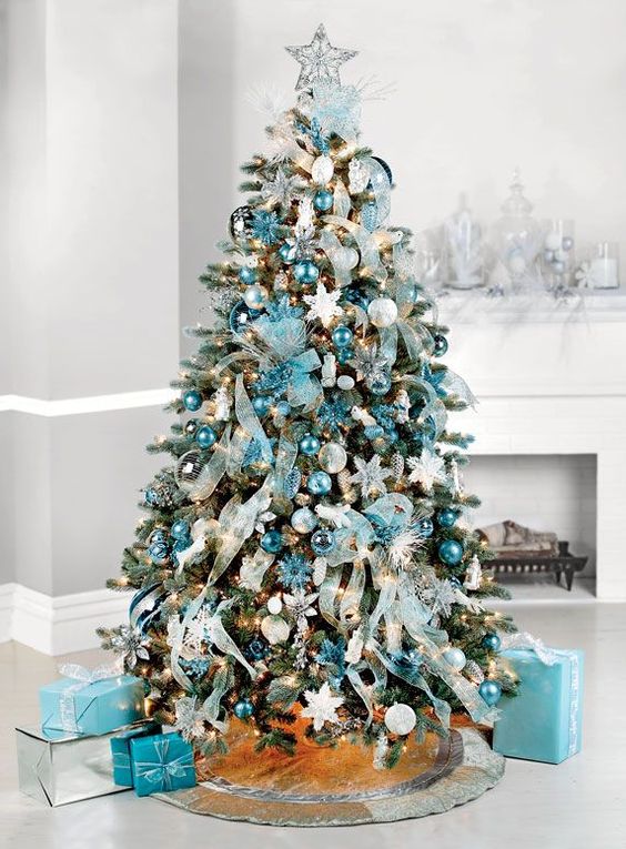 Ribbons, baubles in all shades of blue, snowflakes, and gift boxes in blue are used for decorating this gorgeous tree.