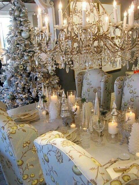 Royal dining room decoration with candles, artificial tree, chandelier, and golden tree decor.