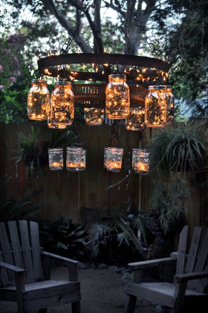 Swanky recycled mason jar chandelier a wine barrel strap and some Christmas lights.