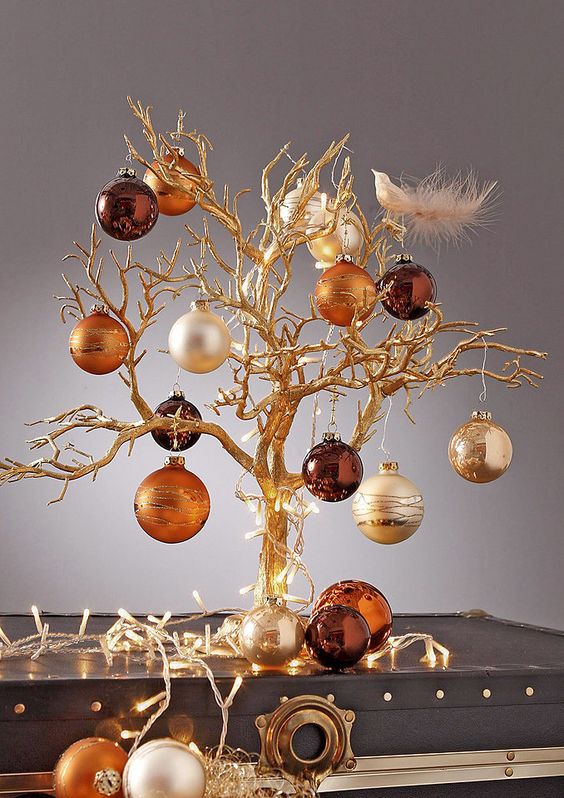 Tabletop Christmas tree with copper, silver, and chocolate ornaments.