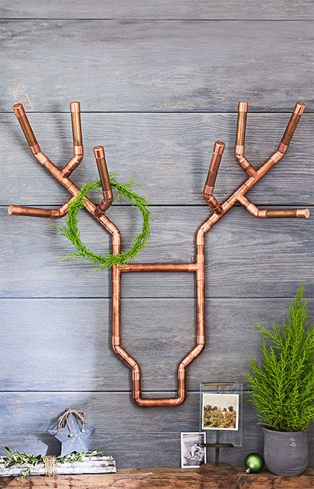 Unique copper pipe wall decor for Christmas.