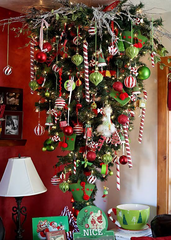 Wonderful upside-down Christmas tree decor with red and white candy canes, ornaments, glass baubles, and even elf caps.