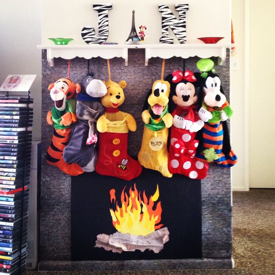 Artificial fireplace and mantel with Disney stockings at Christmas.