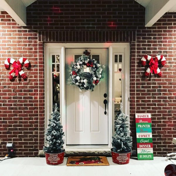 Farmhouse style porch decoration with wreath, tree and Candies on wall