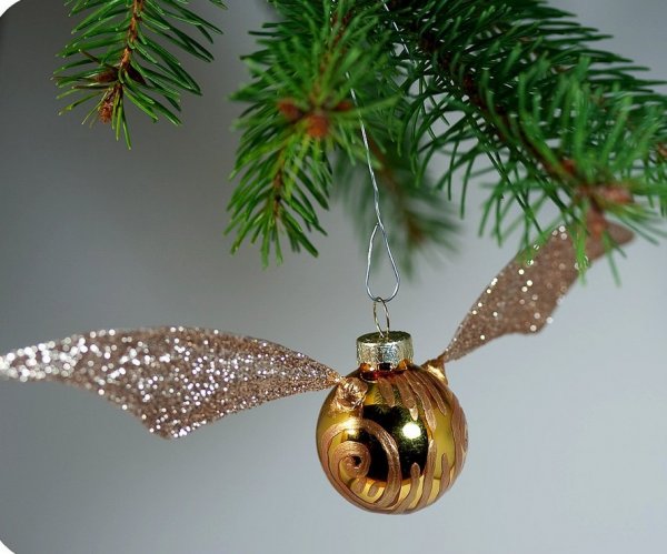 Glittery Golden Snitch ornament for Harry Potter Christmas theme.