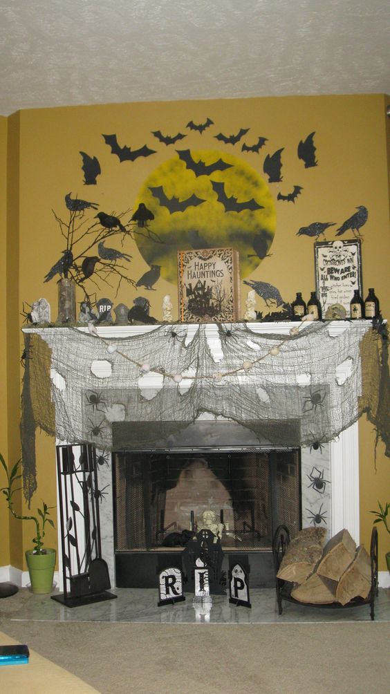 Graveyard mantel decor with bats and a full moon