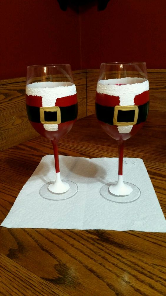 Long stemmed santa suits on wine glass. 