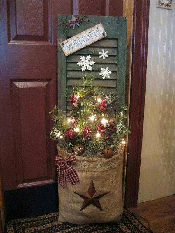 Old door decorated with burlap, jingle bell, red cherries and lights