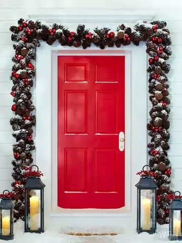 Pinecone garland, red door with lamp on porch