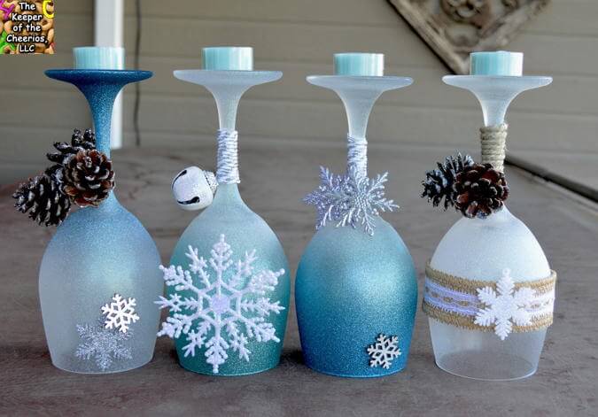 Pretty winter wine glass candle holders decorated with pinecones and snowflakes