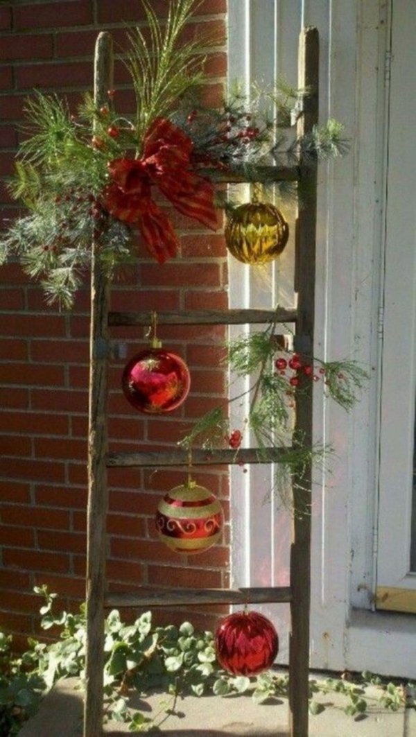 Smart idea to decorate old ladder with big colorful ornaments