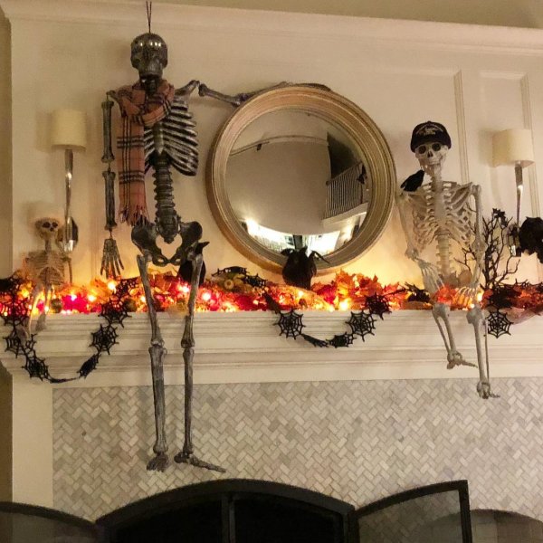 Stylish mantel decor with skeleton and spider web garland