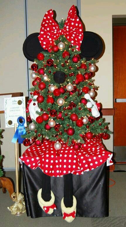 The Tabletop Christmas tree is decorated with a Minnie Mouse theme. 