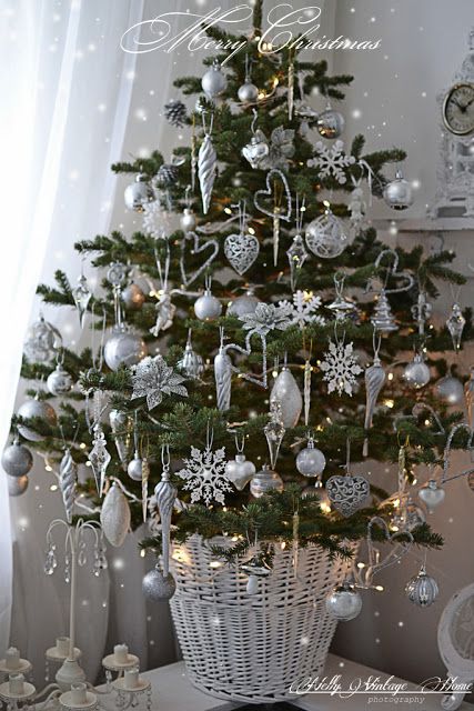 Table-top Christmas tree with white and silver ornaments.