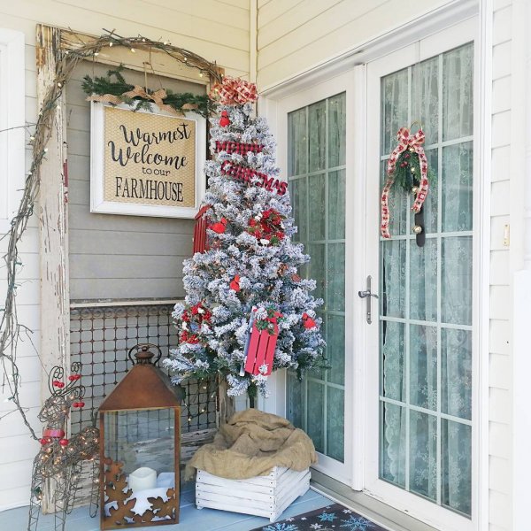 White Christmas tree, wire reindeer, and lamp for porch decoration at Christmas