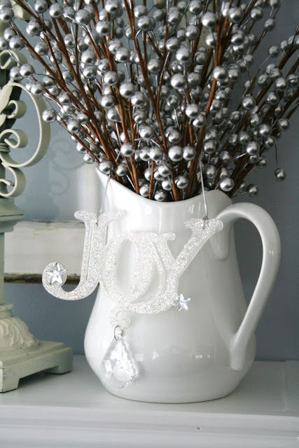 White pitcher, joy ornaments and silver berries look amazing.