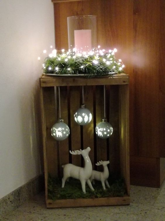 Wooden box decorated with lights, reindeer and bulbs for indoor or outdoor Christmas decoration