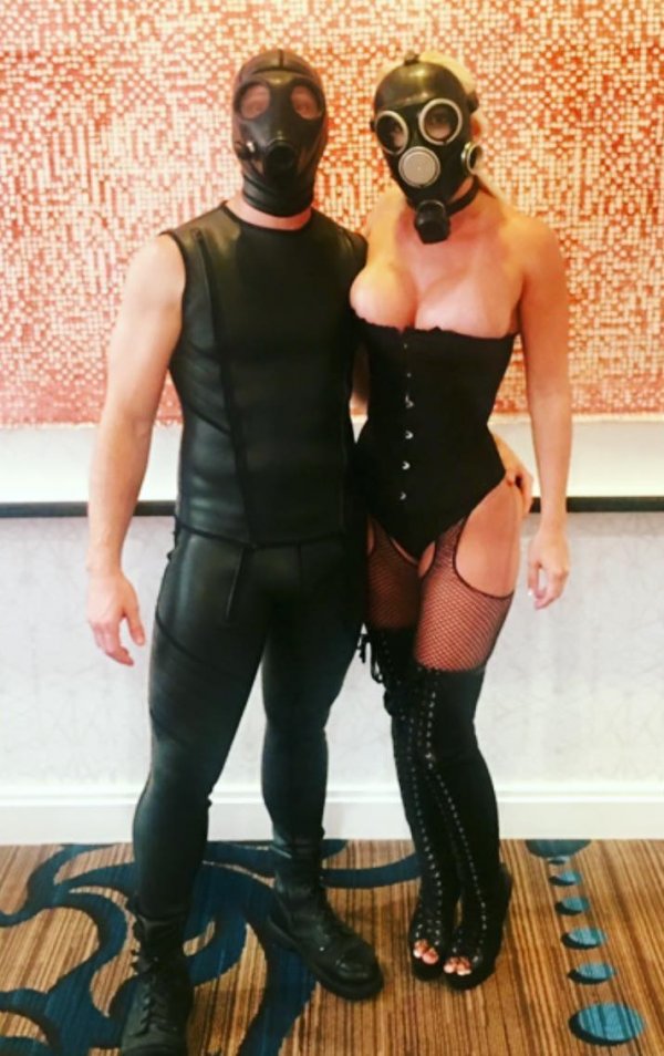 Couple ready for Halloween party with gas mask. 