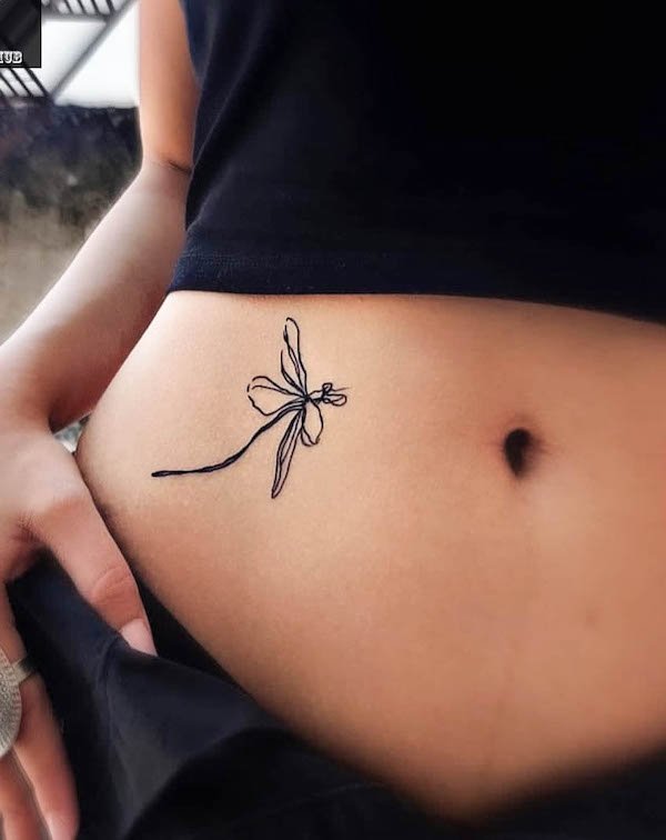 Abstract dragonfly waist tattoo