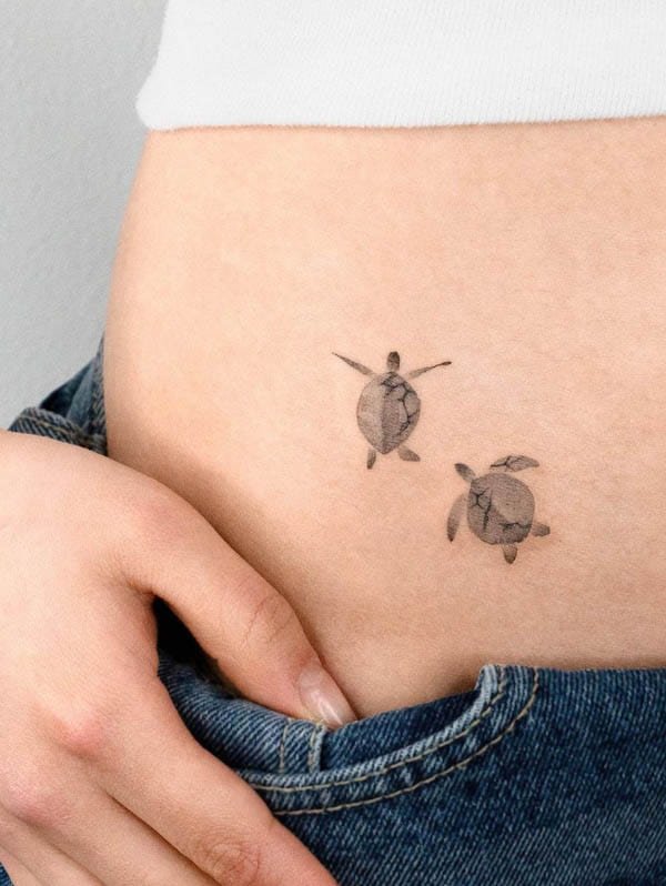 Black and grey turtle waist tattoo