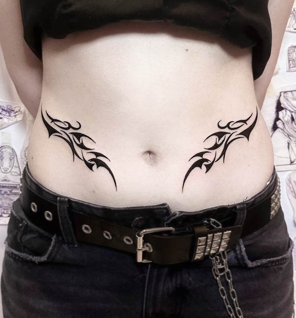 Symmetrical tribal waist tattoo for women